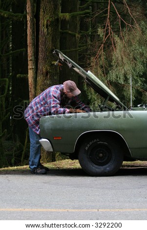 A man tries to figure out what is wrong with his car.
