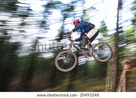 A skilled mountin biker leaps off of a jump near Hood River, Oregon.