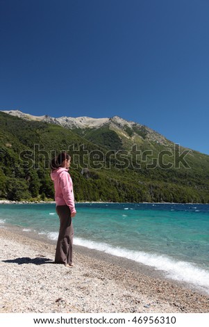 A woman looks out over a beautiful lake in Argentina.