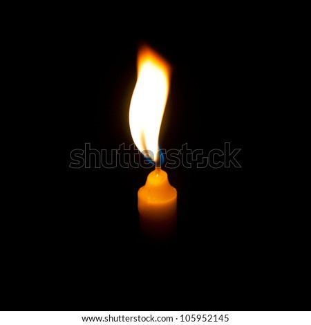 Yellow candle in dark background