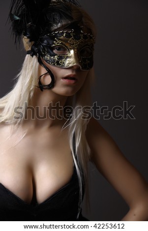 Portrait of beautiful young woman with Venetian mask on her face. Masquerade concept. Studio shot. Isolated on white background.