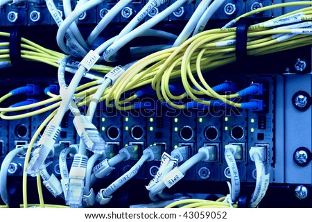 Media Converters. Fiber Optic cables connected to an optic ports and UTP Network cables connected to an Fast/Giga ethernet ports. Data Network Hardware Concept. SC/UPC connectors.