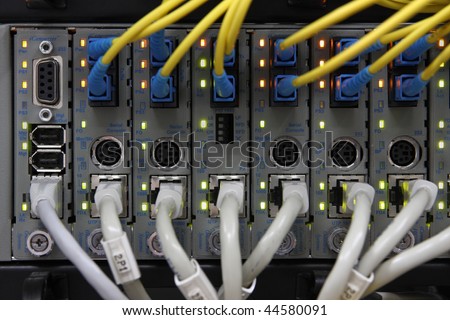 Media Converters. Fiber Optic cables connected to an optic ports and UTP Network cables connected to an Fast/Giga ethernet ports. Data Network Hardware Concept.