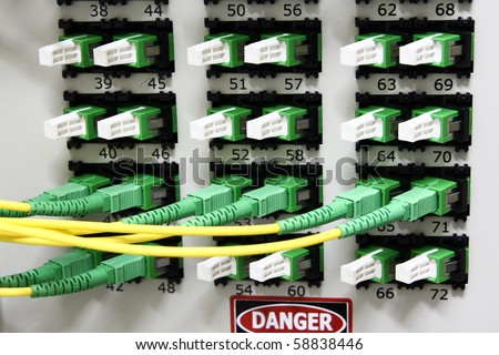 Fiber Optics with SC/APC connectors - Patch Panel. Internet Service Provider equipment. Focus on fiber optic cables. Data Network Hardware Concept.
