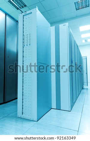 An row of racks in a commercial data center securely housing computers and servers.