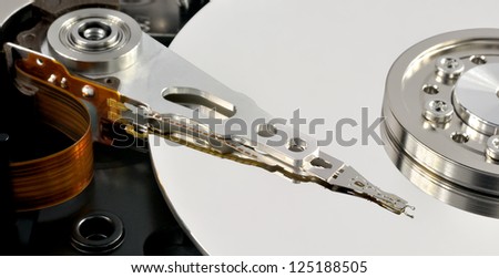 Close up of opened hard disk drive, data saving concept