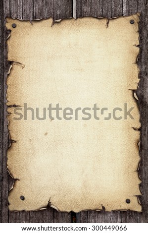 The old yellowed sheet of paper with ragged edges nailed to the boards