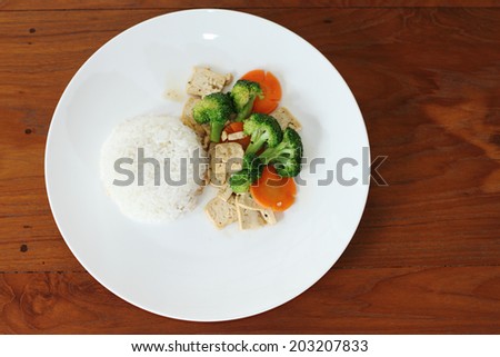 rice with fried bean curd for vegan on wooden background