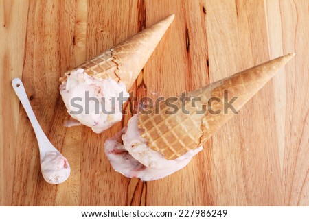 ice cream cones dropped upside down on wooden background