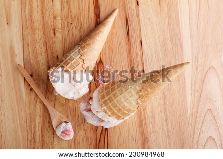 ice cream cones dropped on wooden background