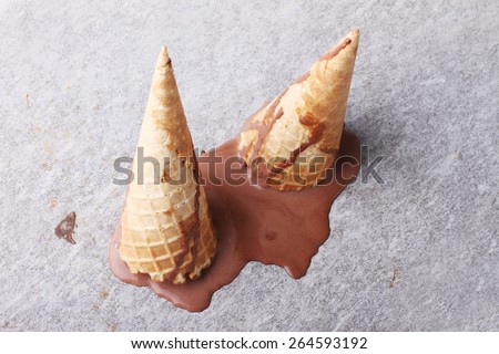 chocolate ice cream cones dropped melt upside down on ground