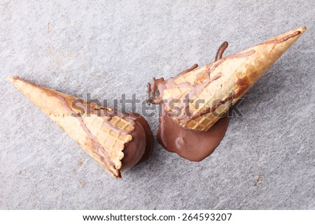 chocolate ice cream cones dropped melt on ground