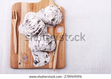 homemade cookie and cream ice cream scoop melting on wooden board