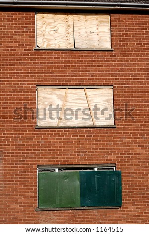Boarded up windows on a derelict block of flats/apartments