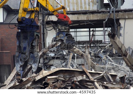 Demolition of disused building in progress showing rubble and twisted steel