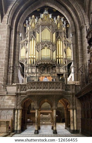 The magnificent organ inside Chester Cathedral being played with sand stone architecture