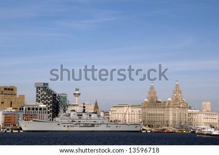 Liverpool Waterfront with the Royal Navy Ship Ark Royal berthed on the docks showing the famous Liverbirds and Mersey Ferry.
