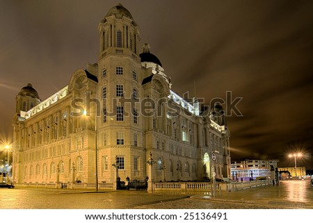 Port of Liverpool building lit up at night.