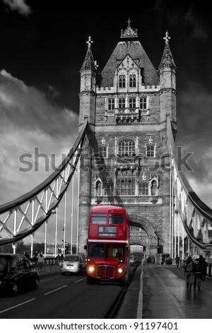 Red London Bus driving across Tower Bridge
