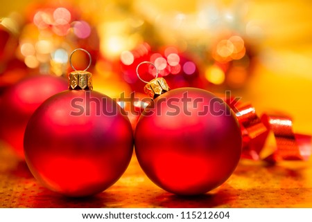 Red Christmas balls on a gold background