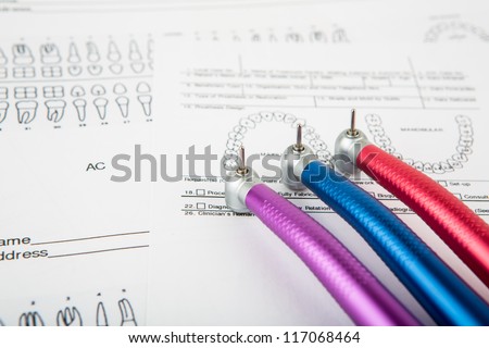 Dental tools and equipment on dental chart