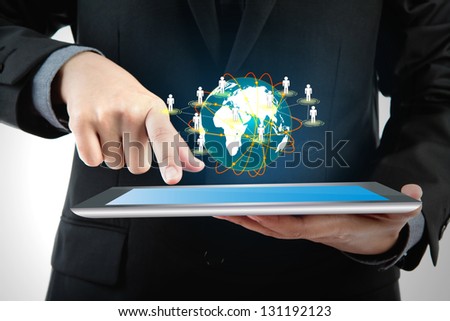Business man using a touch screen device with social network (Elements of this image furnished by NASA)