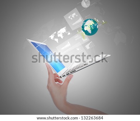 Hand holding thin laptop with screen and graph,social network out
