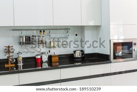 Kitchen cabinets with coffee corner in modern home living room.