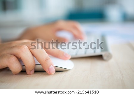 Closeup of business woman hand typing on keyboard and mouse