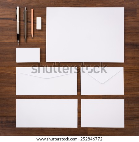 Blank Template. Consist of Business cards, letterhead a4, pen, envelopes,pencil,eraser on wood table