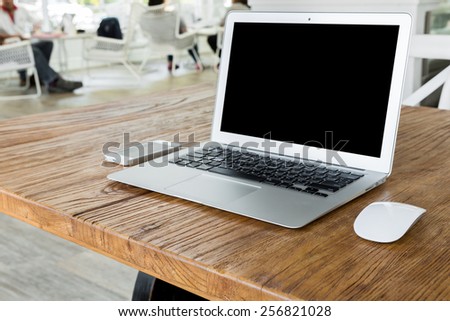 Blank screen laptop computer on wood table