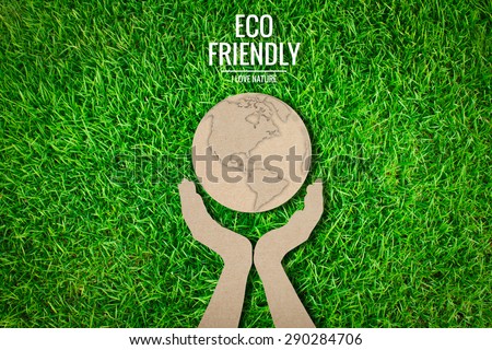 Paper cut of  eco friendly earth on green grass