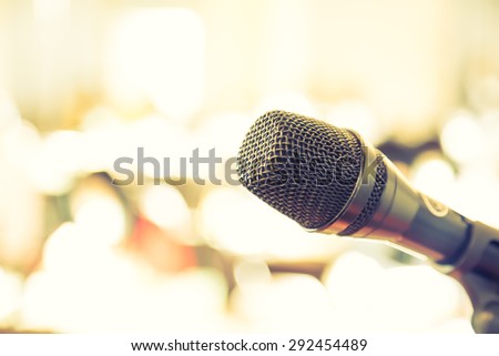 Black microphone in   conference room ( Filtered image processed vintage effect. )