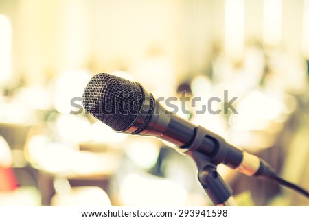 Black microphone in   conference room ( Filtered image processed vintage effect. )