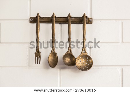 Vintage kitchen spoon  and fork hanging on wall ( Filtered image processed vintage effect. )