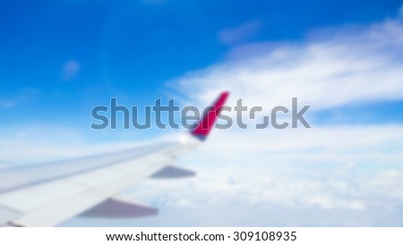 Abstract blur Wing of an airplane flying above the clouds