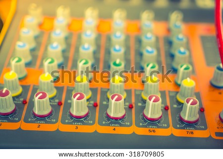 Music mixer desk with various knobs ( Filtered image processed vintage effect. )