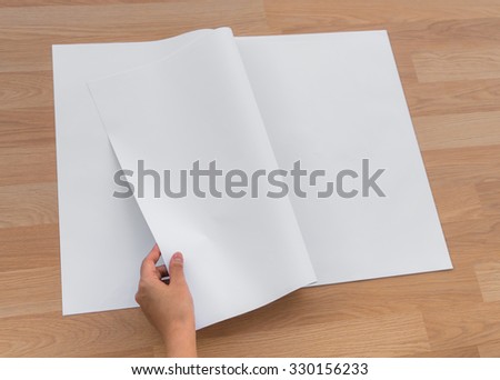 Hand hold Blank Newspaper with empty space mock up on wood background