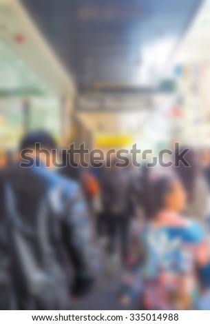 Abstract blur Crowd of anonymous people walking on busy  street