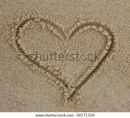Heart drawing in the sand on the beach