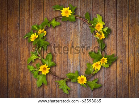 stock photo Beautiful yellow flower crown Daisy on wooden wall