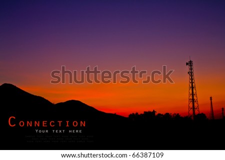 Satellite dishes and communications tower over sunset.
