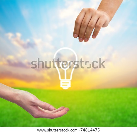 From hand to hand the light bulb as a symbol of Idea.