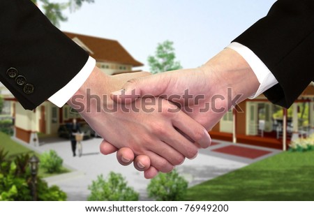 Businessman hand shake hands in front of new home