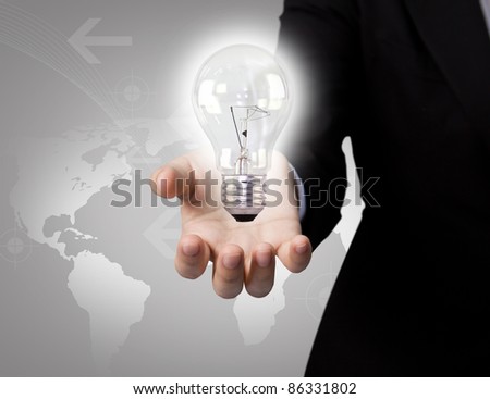 Business woman holding light bulb in hand