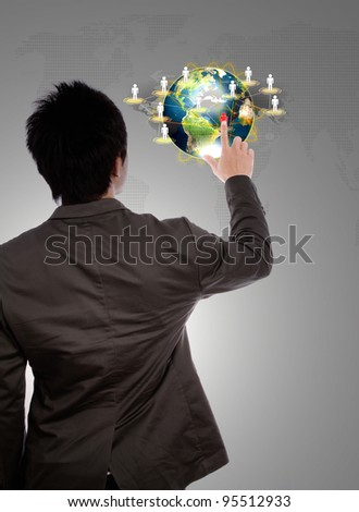 Back view of a young business man pointing at earth of social network