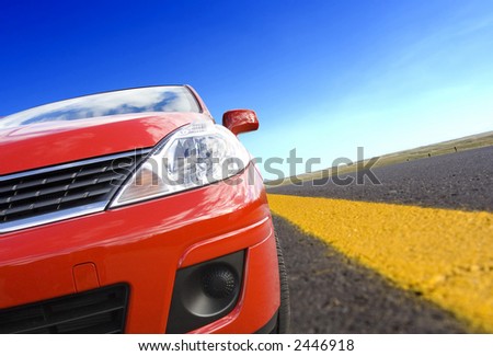 Red car on a  road with yellow line(tilted)
