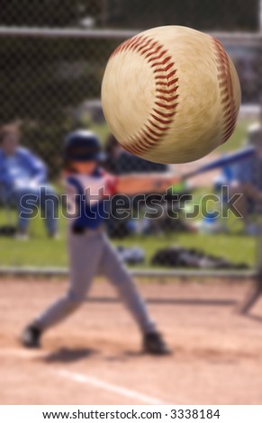 Young baseball player hitting a home run , focus on the ball with motion blur