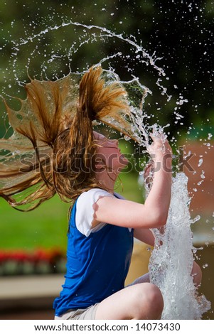 A young girl cooling off on a hot summer day