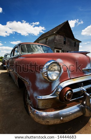 stock photo Old vintage cars left to rust in a ghost town